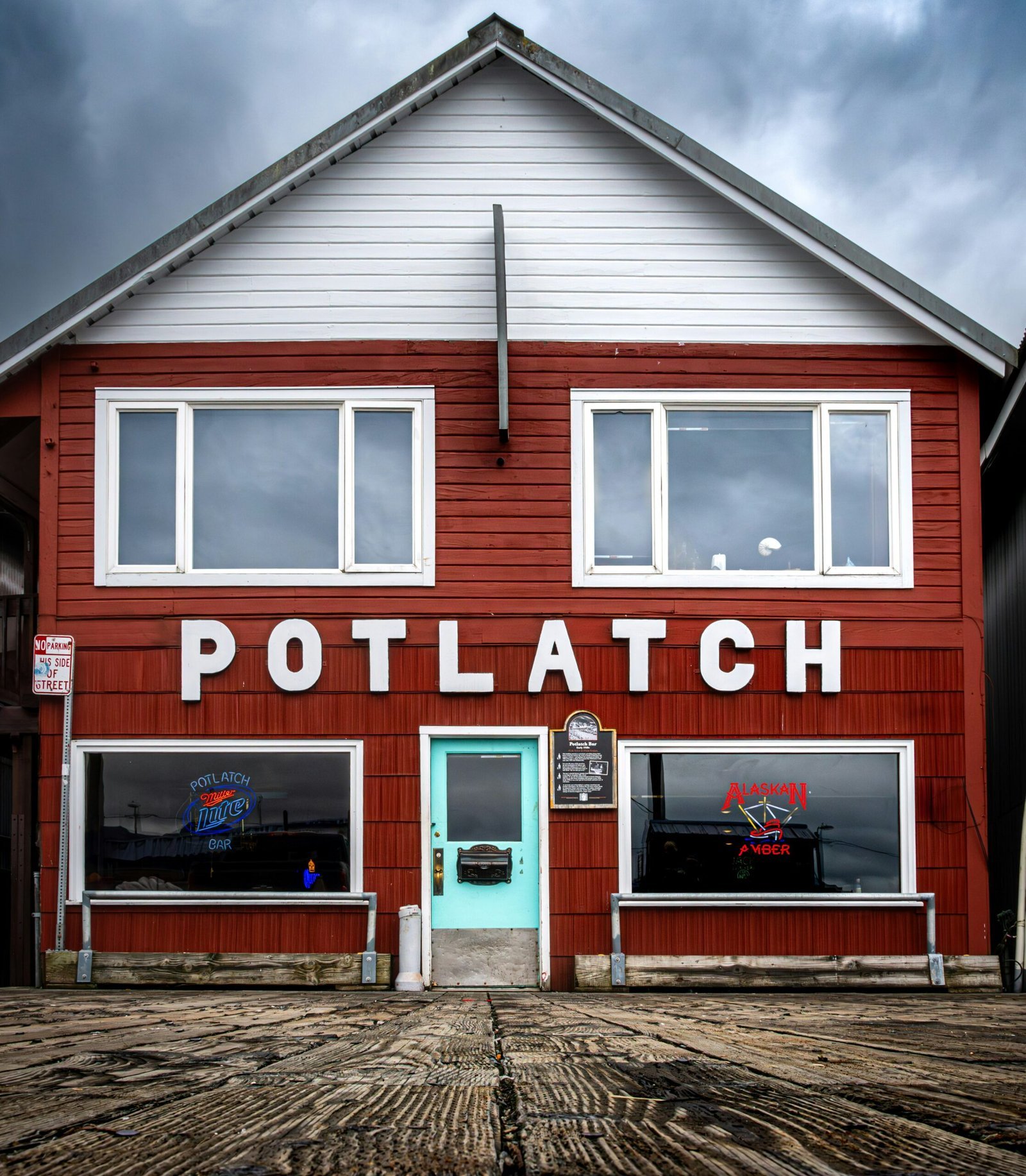 A red building with a blue door and windows